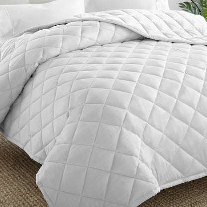 Whisper organics GOTS and fairtrade certified diamond stitch square white comforter laid out on bed
