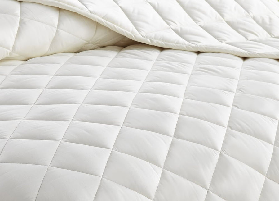 Organic cotton filled comforter with a soft quilted surface.