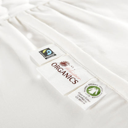Zoomed-in view of the Whisper Organics logo next to GOTS and Fairtrade certification.