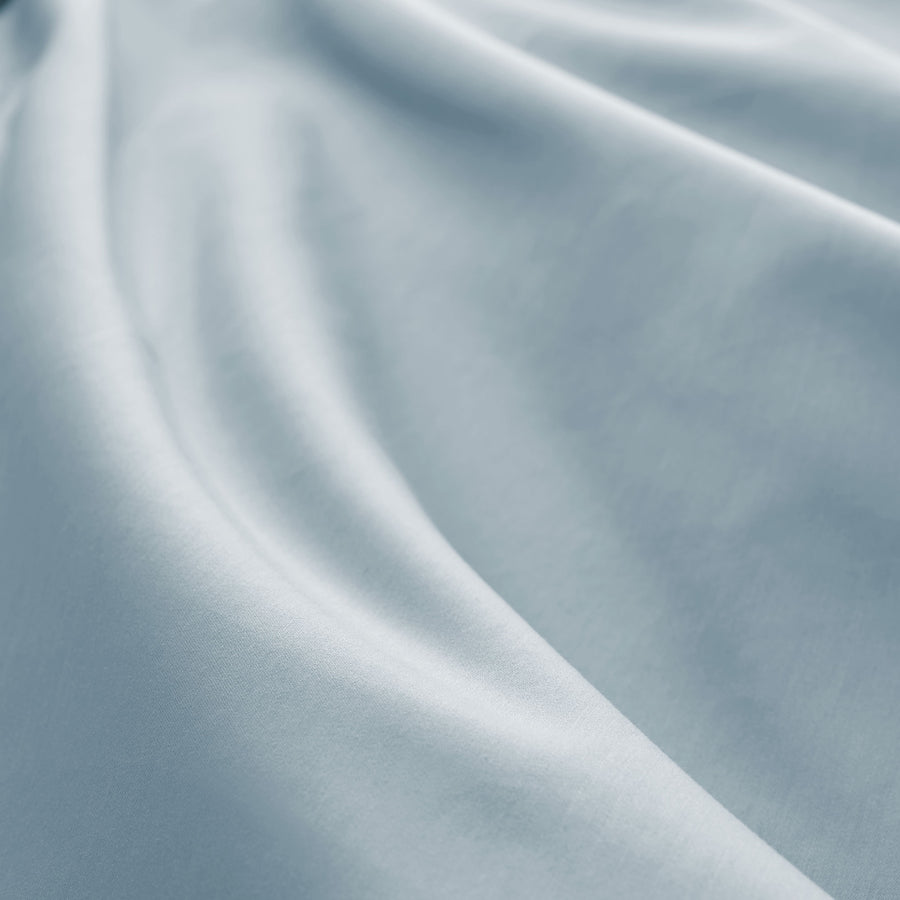 Close-up of soft, draped sateen cotton fabric in powder blue.