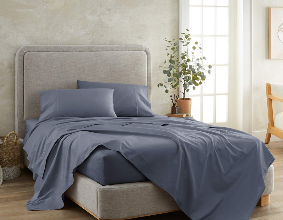 Sateen cotton sheet set styled on a bed in mineral blue.